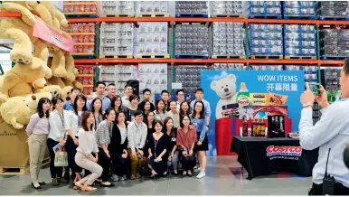  ??  ?? U.S. wholesale chain Costco opened its first store in China’s mainland in Shanghai on August 27, 2019. Its retail staff pose for a group photo on August 20 before opening.