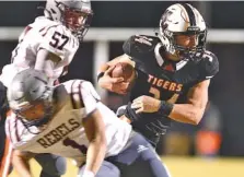  ?? STAFF PHOTO BY ROBIN RUDD ?? Meigs County’s Will Meadows, right, avoids a South Greene defender on the way to the end zone for one of his six touchdowns during Friday night’s home victory in the TSSAA Class 2A quarterfin­als. The Tigers won 42-14 to improve to 13-0 and will travel to Trousdale County for next week’s semifinals.