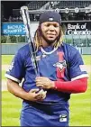  ??  ?? American League’s Vladimir Guerrero Jr., of the Toronto Blue Jays, holds the MVP trophy after the MLB All-Star baseball game, on July 13, in Denver. (AP)