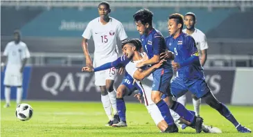  ?? AFP ?? Thai men’s players, in blue, in action against Qatar.