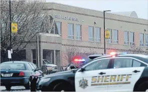  ?? SUSAN WALSH THE ASSOCIATED PRESS ?? Police converge on Great Mills High School, the scene of a shooting, Tuesday in Great Mills, Md. .