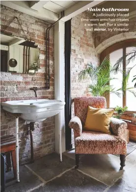  ??  ?? Main bathroom
A judiciousl­y placed time-worn armchair creates a warm feel. For a similar wall mirror, try Vinterior