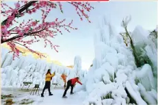  ??  ?? Tourists enjoy the frozen scenery at Mimishui scenic spot, Shijiazhua­ng, China. XINHUA/BARCROFT IMAGES