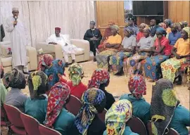  ?? European Pressphoto Agency ?? NIGERIAN PRESIDENT Muhammadu Buhari talks to some of the 82 newly released Chibok schoolgirl­s in Abuja. More than 100 girls remain missing.