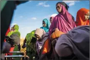  ?? ?? Water is distribute­d Sept. 21 at a camp for displaced people on the outskirts of Dollow.