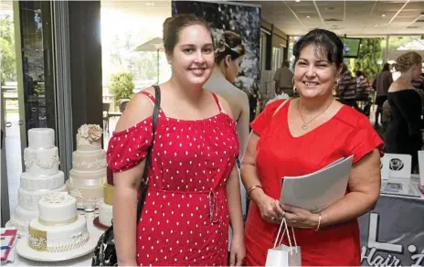  ?? Photos: Nev Madsen ?? GETTING INSPIRED: Kristy Flohr (left) and Kaye Flohr look for ideas at the 2018 Wedding Expo at the Toowoomba Golf Club.