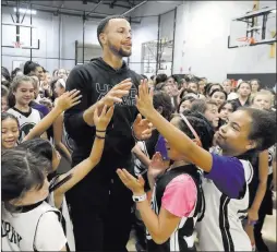  ?? Jeff Chiu ?? The Associated Press Golden State’s Stephen Curry greets campers at the Ultimate Fieldhouse in Walnut Creek, Calif. For the first time, Curry, father to two young daughters, hosted a girls-only free Warriors-run camp.