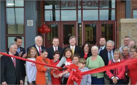  ?? SUBMITTED PHOTO ?? Owen J. Roberts School District officials and students, joined by elected officials, cut the ribbon to officially open the new East Coventry Elementary School on Friday.