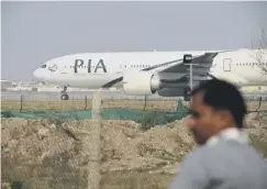  ??  ?? 0 A Pakistan Internatio­nal Airlines plane on the runway