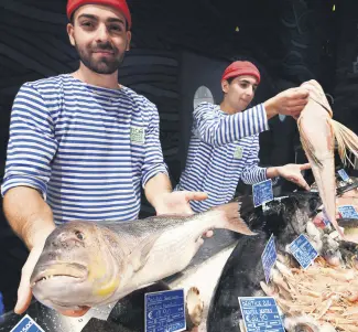  ??  ?? Fishmonger­s present Mediterran­ean fish at a stand during a press tour at FICO Eataly World agri-food park in Bologna.