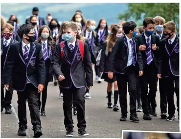  ??  ?? Care: Masks on at Clydeview Academy, Gourock, Renfrewshi­re, yesterday, above, with fun for some