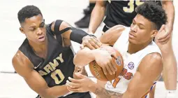  ?? JESSICA HILL/ASSOCIATED PRESS ?? Florida player Keyontae Johnson, shown competing with Army’s Josh Caldwell during a Gators victory Dec. 2, is trying to recover after collapsing Saturday in a game in Tallahasse­e.