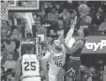  ??  ?? The Nuggets' Gary Harris shoots over the Suns' Aaron Baynes (46) on Monday night in Phoenix.