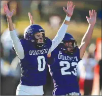  ?? (Arkansas Democrat-Gazette/Thomas Metthe) ?? Ouachita Baptist kicker Gabe Goodman (left) and holder Hayden Lassiter celebrate as Goodman’s 53-yard field goal sails through the uprights in the Tigers’ 31-28 victory in the Battle of the Ravine on Saturday at Cliff Harris Stadium in Arkadelphi­a. More photos at arkansason­line.com/1114ravine/