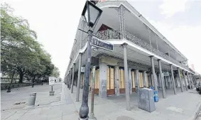  ?? Gerald Herbert, The Associated Press ?? Businesses, normally bustling with tourists, are closed Friday in Jackson Square in New Orleans’ nearly deserted French Quarter.