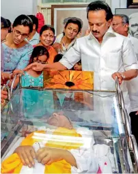  ?? PTI ?? DMK leader MK Stalin stands alongside the mortal remains of his father and DMK chief M Karunanidh­i on Wednesday. —