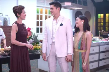  ?? — Photo by Sanja Bucko, Warner Bros. Pictures ?? (From left) Tan Sri Michelle Yeoh, Henry Golding and Constance Wu star in “Crazy Rich Asians.”