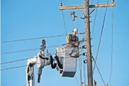  ?? [DOUG HOKE/ THE OKLAHOMAN] ?? A crew from Power Grid Services, in Hartselle, Alabama, works on N Laird Avenue near NE 24 Street to restore power in the area Monday.