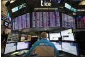  ?? MARK LENNIHAN — THE ASSOCIATED PRESS FILE ?? A trader works at the New York Stock Exchange. Stocks wobbled Tuesday as large high-dividend stocks rose and smaller companies sank.