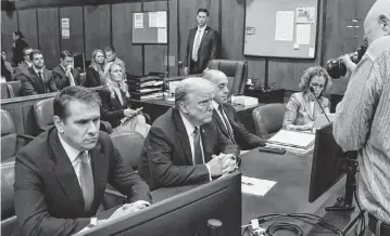  ?? BRENDAN MCDERMID Pool/Getty Images/TNS ?? Former President Donald Trump, second from left, appears in court for opening statements in his trial in Manhattan Criminal Court on Monday for allegedly covering up hush money payments linked to his 2016 presidenti­al campaign.