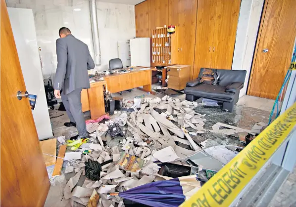  ?? ?? Officials inspect damage caused by radical Jair Bolsonaro supporters at the Planalto Palace in Brasilia as the clean-up begins. President Lula da Silva condemned the violence and vandalism as ‘terrorism’