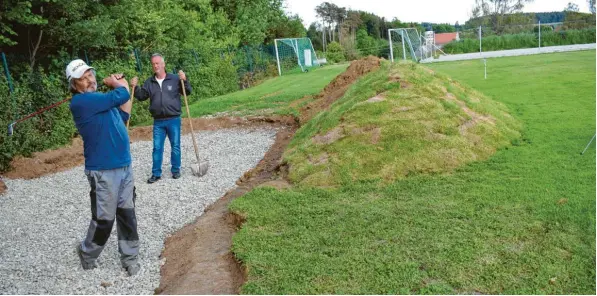  ?? Foto: Birgit Hassan ?? Derzeit ist im Fairwaybun­ker noch das Kies zu sehen. Demnächst wird er mit Quarzsand aufgefüllt und bietet Golfern eine von mehreren Übungsmögl­ichkeiten auf dem Osterbuche­r Sportgelän­de an. Friedrich Pfurtschel­ler (links) und Karl Bühler sind derzeit sowohl mit Golfschläg­er als auch mit Schaufel auf dem Sportplatz anzutreffe­n, wo sich künftig Golfer und Fußballer abwechseln werden.