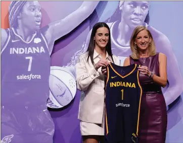  ?? ADAM HUNTER/THE ASSOCIATED PRESS ?? Iowa’s Caitlyn Clark, left, is photograph­ed with WNBA commission­er Cathy Engelbert after being selected first overall by the Indiana Fever during the first round of the WNBA basketball draft in New York on Monday.