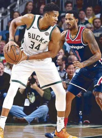  ?? AFP ?? Giannis Antetokoun­mpo (34) of the Milwaukee Bucks handles the ball during the game against the Washington Wizards at the Fiserv Forum Center in Milwaukee, Wisconsin.