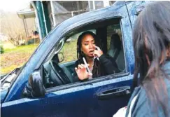  ?? AP FILE PHOTO/DAVID GOLDMAN ?? Larrecsa Cox, who leads the Quick Response Team, demonstrat­es to Yvonne Ash outside her home in Branchland, W.Va., how to administer the overdose reversal medication naloxone, just days after her son overdosed.