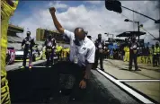  ?? BRYNN ANDERSON — THE ASSOCIATED PRESS ?? A NASCAR official kneels during the national anthem before Sunday’s NASCAR Cup Series race at Atlanta.