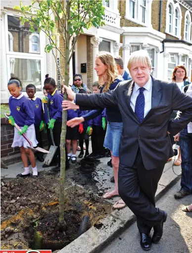  ??  ?? Environmen­tal champion: Boris Johnson planting a tree