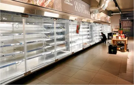  ??  ?? A supermarke­t’s meat fridges are empty as people stock up on food after the SA government announced measures to curb coronaviru­s infections. Picture: REUTERS/Rogan Ward