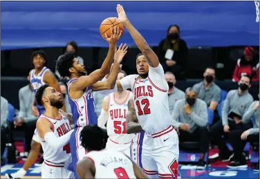  ?? Associated Press ?? Playing big: Philadelph­ia 76ers' Isaiah Joe, left, goes up for a shot against Chicago Bulls' Daniel Gafford in Philadelph­ia. Gafford, of El Dorado, had two blocked shots and a rebound in the Bulls' 112-105 loss.