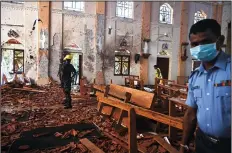  ?? JEWEL SAMAD/AFP/GETTY IMAGES ?? Security personnel inspect the interior of St Sebastian’s Church in Negombo on Monday, a day after the church was hit in a series of bomb blasts targeting churches and luxury hotels in Sri Lanka.