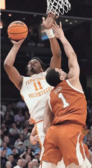  ?? JIM DEDMON/USA TODAY SPORTS ?? Tennessee forward Tobe Awaka (11) shoots against Texas forward Dylan Disu (1) in the second round of the NCAA Tournament on Saturday at the Spectrum Center in Charlotte, NC.