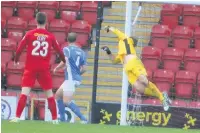  ??  ?? Sam Ramsbottom pushes a shot round the post