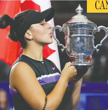  ?? ELSA / GETTY IMAGES ?? Bianca Andreescu of Canada kisses the championsh­ip trophy on Sunday after winning the U.S. Open tennis tournament in New York City. The 19-year-old has inspired fans with her hard work and positive attitude.