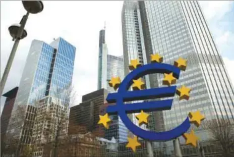  ??  ?? The stars of European Union (EU) membership sit on a euro sign sculpture outside the headquarte­rs of the ECB in Frankfurt. After more than three years and purchases of €2.6tn ($3.0tn) of government and corporate bonds, the ECB should announce as planned tomorrow the end of its “quantitati­ve easing” programme, after months of step-wise winding-down.