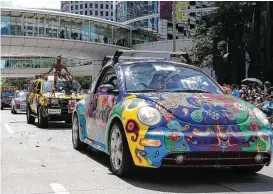  ?? Yi-Chin Lee / Houston Chronicle ?? Crowds at the Art Car parade expect to see brilliant colors, vivid decoration­s and, especially, peculiar ornaments as demonstrat­ed on these entries.