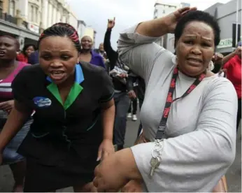  ?? AFP/GETTY IMAGES ?? People run after a skirmish between local residents and foreign nationals during a march in Durban.