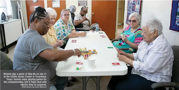  ?? Staff photo by Hunt Mercier ?? Women play a game of Skip-Bo on July 11 at the Collins Senior Center in Texarkana,
Texas. Seniors enjoy playing games for the companions­hip, and it helps deal with
injuries they've acquired.