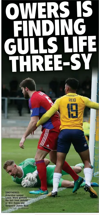  ?? PICTURE: Ian Morsman ?? SMOTHERED: Aldershot keeper Lewis Ward gathers the ball from defender Will Evans and Torquay’s Jamie Reid