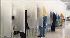  ?? Tony Dejak / Associated Press ?? In this Oct. 6 photo, voters fill out their ballot during early voting at the Cuyahoga County Board of Elections in Cleveland. The Cybersecur­ity and Infrastruc­ture Agency, which President Donald Trump signed into existence in 2018, is working with other parts of the government to safeguard an election in the middle of a pandemic.