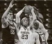  ?? Bruce Kluckhohn / Associated Press ?? Brandon Johnson (23) hit four 3-pointers in overtime to help Minnesota defeat No. 4 Iowa.