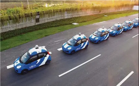  ??  ?? Growth strategy: A fleet of vehicles equipped with Baidu’s autonomous driving technologi­es conduct road testing in Wuzhen, Zhejiang Province. Widely considered the Google of China, Baidu is hoping research into artificial intelligen­ce will create a new...