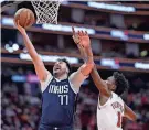  ?? TROY TAORMINA/USA TODAY SPORTS ?? Mavericks guard Luka Doncic shoots against Rockets forward Amen Thompson on Sunday in Houston.