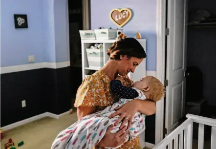  ?? Brontë Wittpenn/The Chronicle ?? Geri Landman holds her daughter Lucy before bed. Lucy’s rare genetic disorder has been found in only 50 cases worldwide.