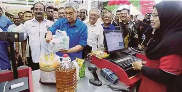  ??  ?? AHMAD Zahid membeli barang selepas merasmikan Kedai Serbanika Pro-Mart dan Pelancaran Program Kos Sara Hidup Rakyat di Hutan Melintang, semalam.