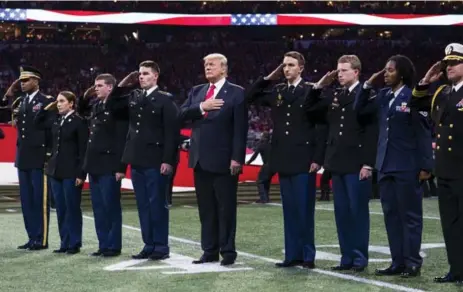  ?? DOUG MILLS/THE NEW YORK TIMES ?? At a college football championsh­ip game Monday, U.S. President Donald Trump appeared to mouth the wrong words to “The Star-Spangled Banner.”