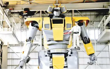  ??  ?? Sakakibara Kikai’s engineer Go Sakakibara poses with the bipedal robot Mononofu during its demonstrat­ion at its factory in ShintoVill­age, Gunma Prefecture. — Reuters photo